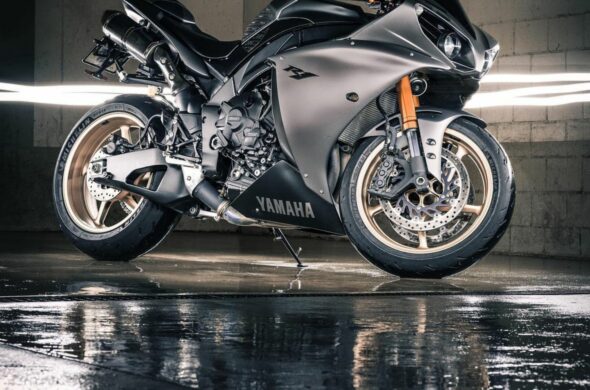 A silver Yamaha YZF-R1 is reflected in the wet floor below Photo by Abhinav Toppo from Pexels