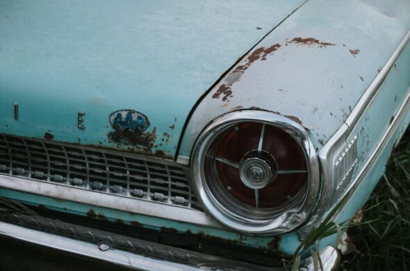 A light blue classic car is weathered by age and neglect. Photo by Karlee Heck from Pexels