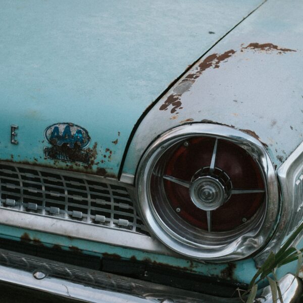 A light blue classic car is weathered by age and neglect. Photo by Karlee Heck from Pexels