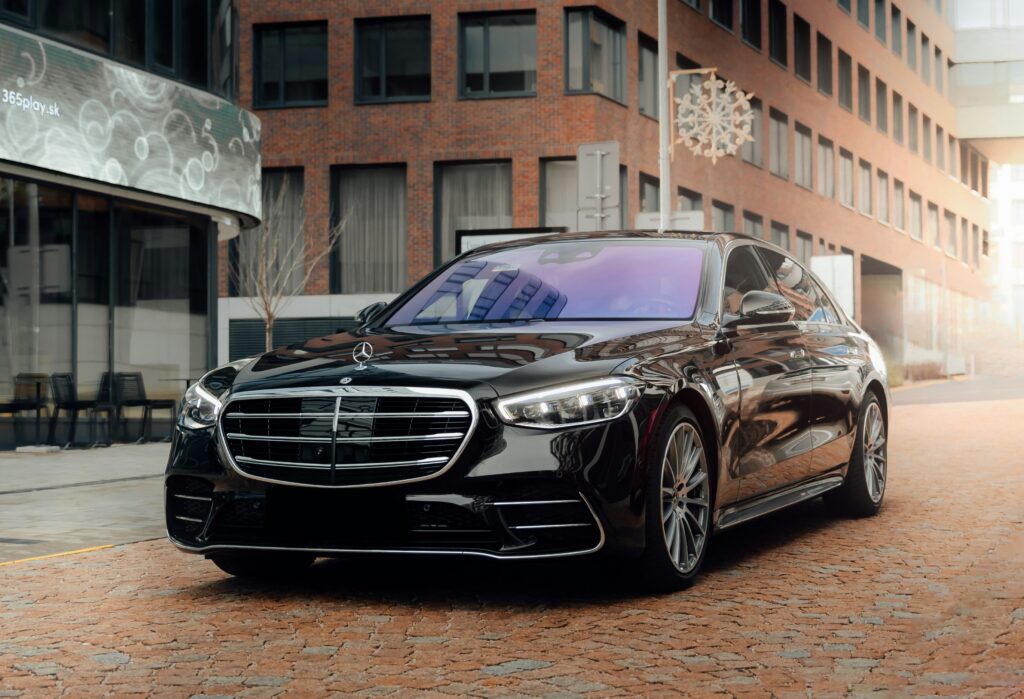 A black Mercedes S Class parked on a brick street.
Photo by Martin Katler from Unsplash