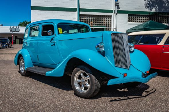 Close-up of a blue vintage car's front grill