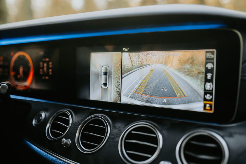 A futuristic looking interface shows footage from the car's backup camera.
Photo by Luke Miller from Pexels