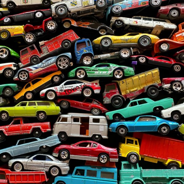 A series of different colored cars, trucks, and vans Photo by _Wokandapixels from Pexels