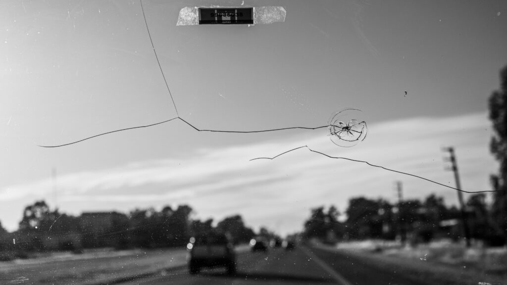 A crack in the windshield as seen from the driver's seat.
Photo by Alex Dos Santos from Pexels.
