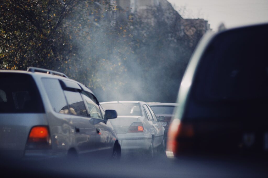 Gridlocked cars create a mist of exhaust on the road.
Photo by Alexey Demidov from Pexels.