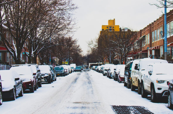 Snow Covered Road and Inline Parked Vehicles