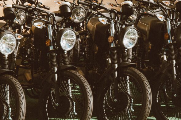 4 vintage motorcycles parked in a sunlit outdoor setting. Photo by Jess Vide from Pexels