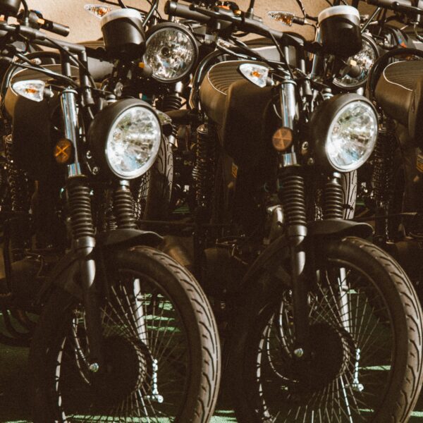 4 vintage motorcycles parked in a sunlit outdoor setting. Photo by Jess Vide from Pexels