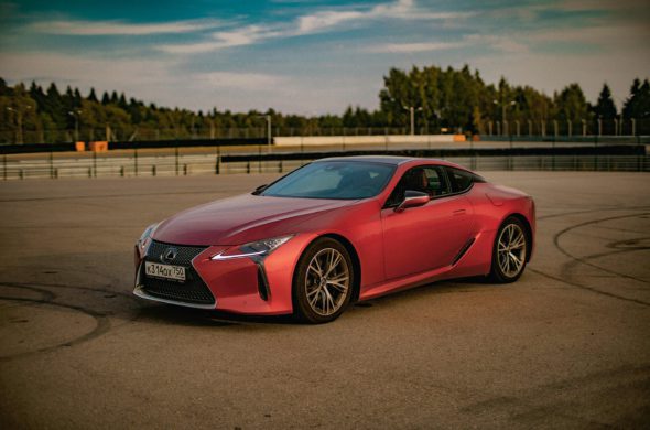 A photo of a red Lexus car in an outdoor setting