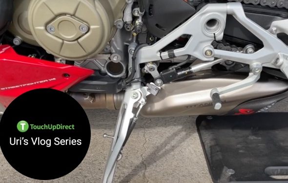 A snippet of a motorcycle focusing on the lower part for TouchUpDirect Uri's Vlog Series
