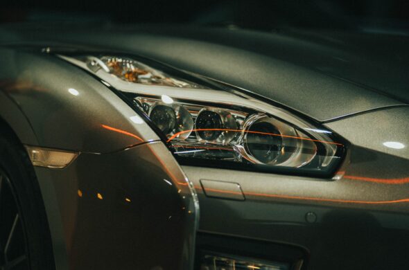 The front of a glossy green sports car. Photo by Alex Hoces from Pexels