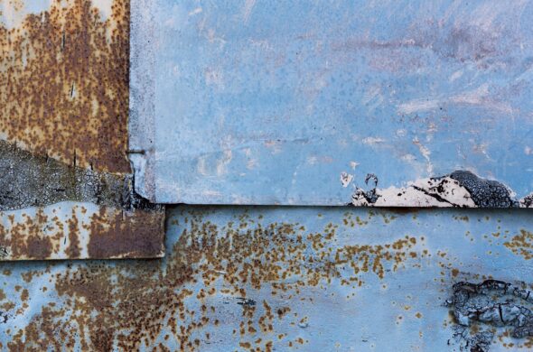 Close up of rust on a blue car. Photo from Magnific