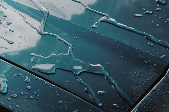 Droplets of water on a blue car Photo by Allan Carvalho from Pexels