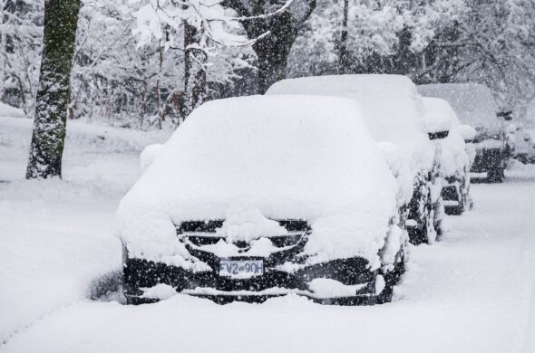 A group of parked cars covered in snow after a storm Photo by Malcolm Gillanders from Pexels