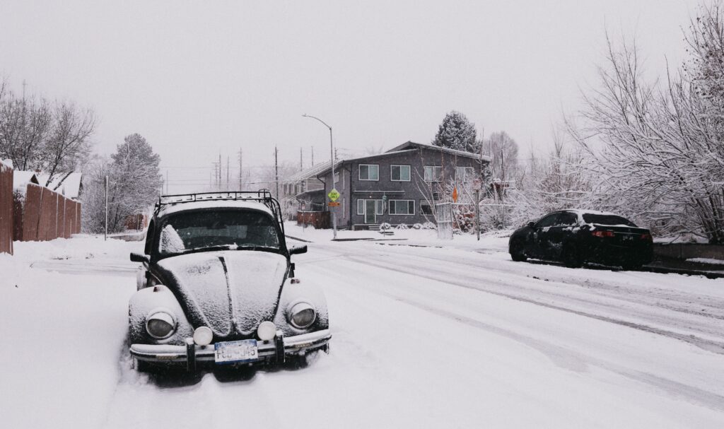 Cars on a snowy street after a storm. Photo by Eduardo Avila Carbajal from Pexels