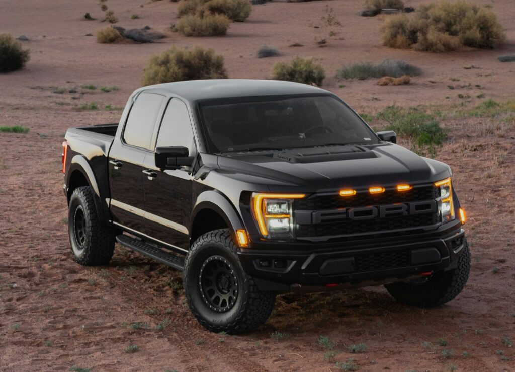 A black Ford F-150 parked in the desert. Photo by Joey Chacon from Unsplash