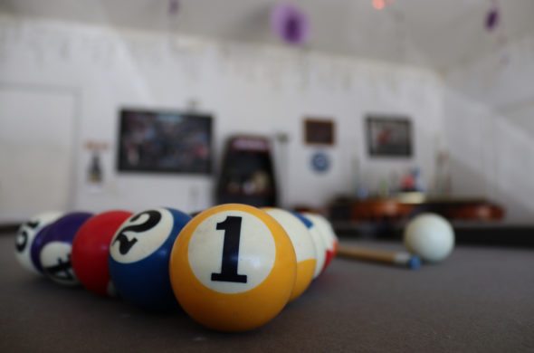 A pitcure of 8 ball pool being focused on an arcade room