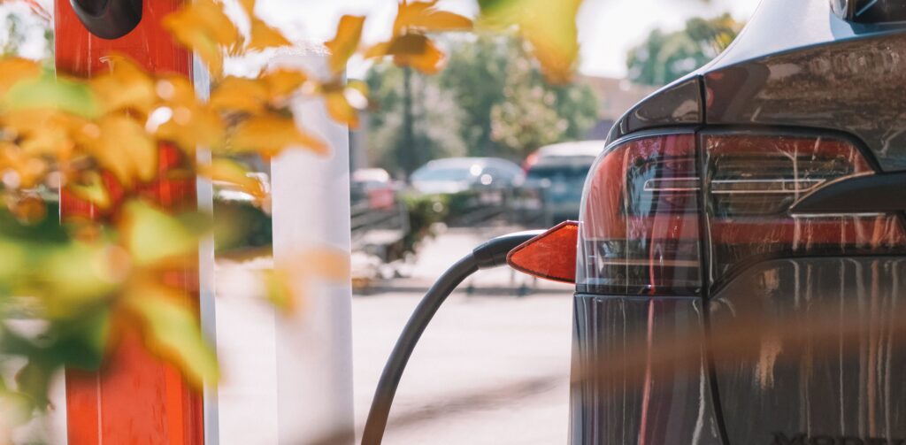 An electric car charges at a station. Photo by Kindel Media from Pexels