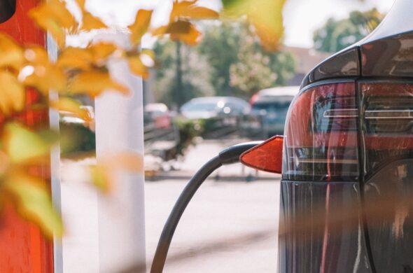 An electric car charges at a station. Photo by Kindel Media from Pexels