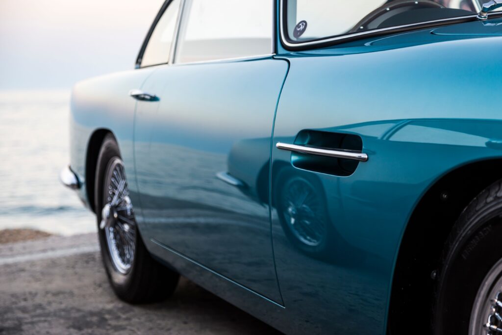 A classic vintage car with polished blue paint near the calm seaside Photo by Quentin Martinez from Pexels