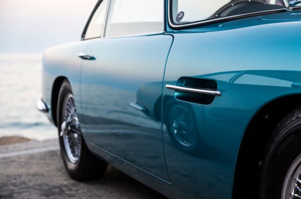 A classic vintage car with polished blue paint near the calm seaside Photo by Quentin Martinez from Pexels