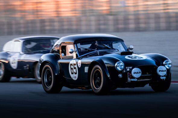 Two classic cars racing intensely on a track during sunset, highlighting speed and competition. From Quentin Martinez from Pexels