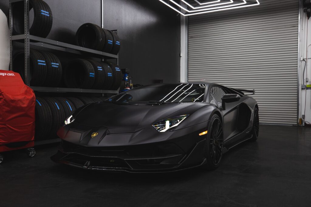 A matte black Lamborghini parked in a garage.
Photo by Jae Park from Pexels