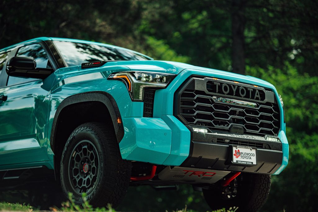 A 2026 Toyota Tundra TRD Pro Hybrid in Wave Maker blue parked in a wooded area.
Photo by Holyson h from Pexels